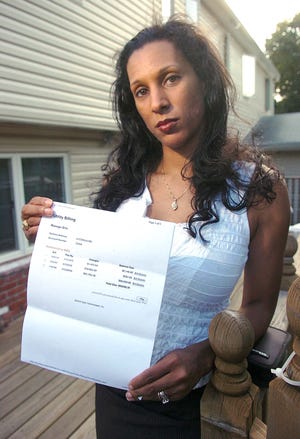 Ayanna YanceyCato holds a water bill from the city of Brockton in the amount of $92439.35 on August 3, 2010. Her bill was later reduced to about $17,000.
