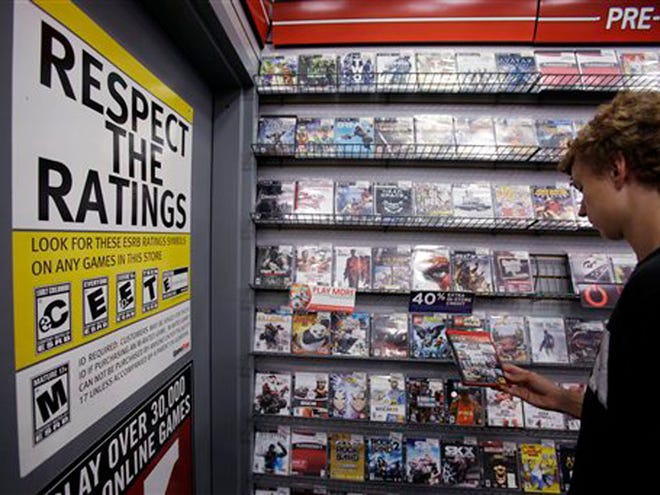 Jack Schooner, 16, looks at Grand Theft Auto video game at GameStop in Palo Alto, Calif., Monday, June 27, 2011. The Supreme Court ruled Monday that it is unconstitutional to bar children from buying or renting violent video games, saying government doesn't have the authority to "restrict the ideas to which children may be exposed" despite complaints that the popular and fast-changing technology allows the young to simulate acts of brutality. (AP)