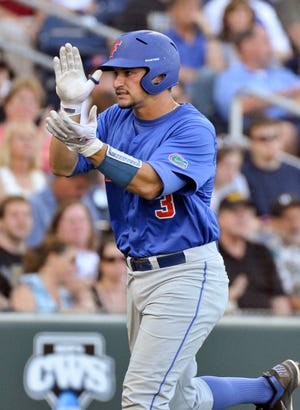 Florida's Mike Zunino celebrates after hitting a solo home run during the fourth inning Tuesday night in Omaha, Neb.