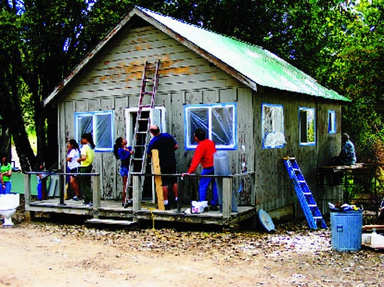 Members of the Stockton Pacifica Lions Club and the McCandless-Larsson Leo Club refurbish a cabin at California Lions Camp for the blind at Camp Pacifica near Yosemite.