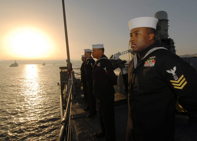Gas Turbine Systems Technician (Mechanical) 1st Class Vincent McKoy mans the rails aboard the guided-missile frigate USS Boone (FFG 28) while arriving in Valparaiso, Chile. Boone rendered honors while passing a line of Chilean ships in the harbor. Boone will join USS Thach (FFG 43) to participate in the Chilean-hosted Pacific phase of UNITAS 52. Boone is deployed to South America in support of Southern Seas 2011.
