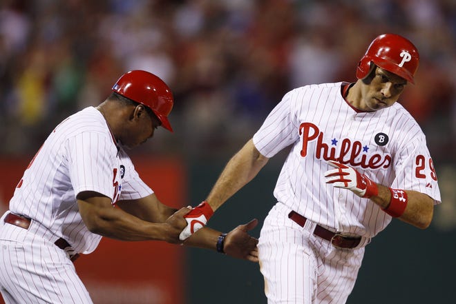 Phillies outfielder Raul Ibanez (right) gets congratulated by third base coach Juan Samuel after hitting a solo home run off Red Sox pitcher John Lackey in the eighth inning of Philadelphia's 2-1 win.