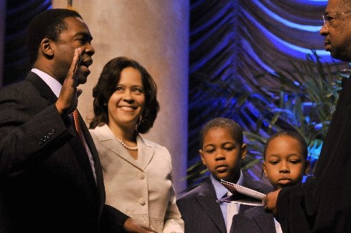 Alvin Brown takes the oath of office flanked by his wife, Santhea, and sons Joshua and Jordan.