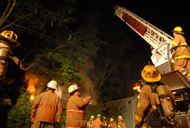 An East Great Plain ladder truck gets ready to douse a burning abandoned house on Bushnell Place in Norwich Thursday, June 30, 2011.