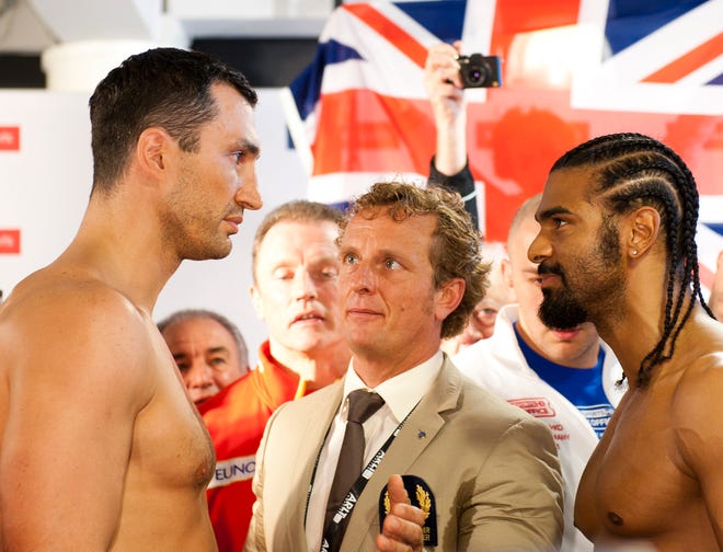 Wladimir Klitschko (left) and David Haye stand face to face Friday after the official weigh-in ahead of today's heavyweight title bout in Hamburg, Germany. The Associated Press