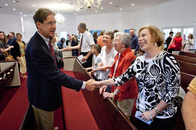Virginia Bayless, right, a member of Laurel United Methodist Church, is greeted by Tom Knox, left, a deacon at Springfield Bible Church.