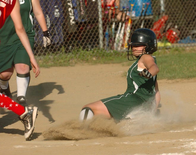 Jewett City's Brianna Kerby slides home for a run during the District 11 Little League softball championship against Norwich-Preston in Griswold Friday, July 1, 2011.