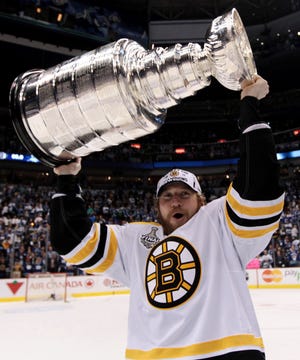 The Bruins' Michael Ryder hoists the cup following his team's 4-0 win over the Canucks in Game 7 of Last Month's Stanley Cup Finals in Vancouver, British Columbia.