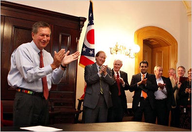 Gov. John Kasich of Ohio, left, after signing the state budget bill into law, at the Statehouse on Thursday in Columbus.