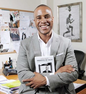 DeVon Franklin, Sony vice president of production and author of
‘Produced by Faith: Enjoy Real Success without Losing Your True
Self,’ poses in his office at Sony Pictures in Culver City, Calif.
Franklin and other producers of faith-based movies have a message
for Hollywood studios: Make the movies and customers will pay to
watch them.
