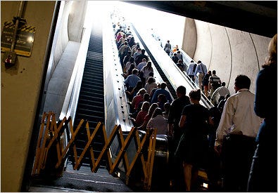 Metro riders crowd onto the only working up escalator at the Capitol South Station outside the Capitol.