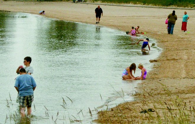In warmer temperatures, City Beach in Cheboygan is a popular area from family fun but — like other Great Lakes’ swimming site — enjoying the cool waters could lead to Swimmer’s Itch.