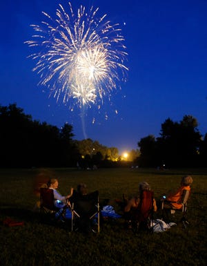 Spectators enjoy the display from a site near Jackson Park. The show was nearly canceled this year for lack of funds.