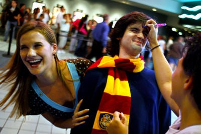 Alexander Borisov of Chatham, 19, is marked with a scar by Stacy Kolaz, left, and Gina Mayes, both 17 and from Springfield, on opening night of Harry Potter and The Order of the Phoenix. The Chatham Area Public Library is holding a Harry Potter Movie Count Down in anticipation of the newest Harry Potter film, "Harry Potter and the Deathly Hallows, Part 2," which open in theaters on July 15.