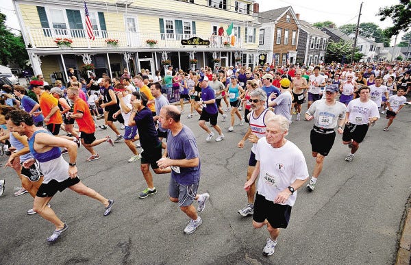 Runners start out on Water Street, as the five-mile Mattapoisett Road race unfolds on Monday morning.