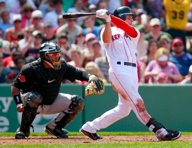 The Red Sox' Jacoby Ellsbury, right, hits a two-run triple in front of Blue Jays' Jose Molina in the fifth inning of Monday's game in Boston. The Blue Jays won 9-7.