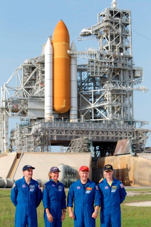 In this June 22 photo, the crew of space shuttle Atlantis, from left, mission specialist Rex Walhiem, mission specialist Sandy Magnus, pilot Doug Hurley and commander Chris Ferguson, attend a news conference at Pad 39A during the Terminal Countdown Demonstration Test at the Kennedy Space Center in Cape Canaveral. The launch of Atlantis, the final space shuttle mission, is scheduled for July 8. (The Associated Press)