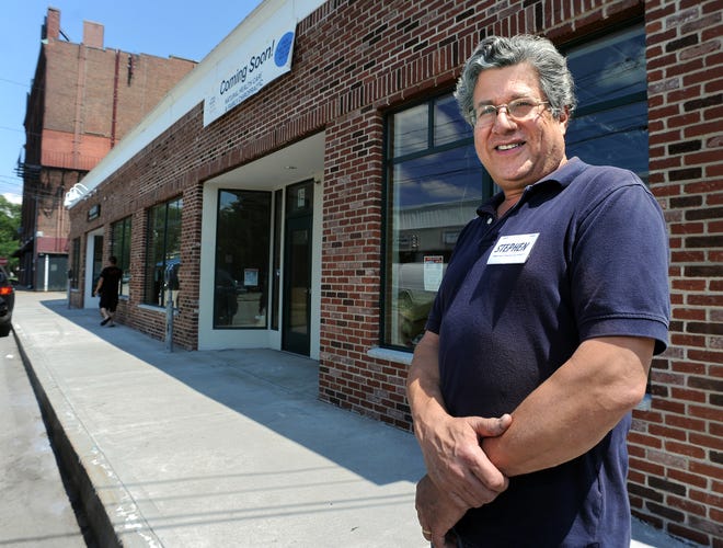 Stephen Weinstein stands outside his new building on Pond Street in Natick on Tuesday. The building replaces the one that burned down and displaced its five commercial tenants in 2008.