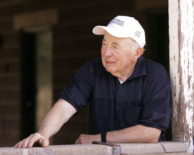 Trainer Tom McCarthy leans on a barn wall as he talks with reporters at Churchill Downs in Louisville, Ky., Saturday, April 25, 2009. McCarthy trains Kentucky Derby hopeful General Quarters.
