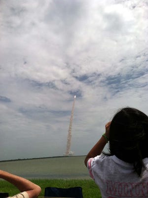 Maryann Bulawa, 15, and her sisters Lilly, 13, Adia, 10 and Jennie, 7, were at the Kennedy Space Center in Cape Canaveral, Fla., July 8, 2001, to see the historic final shuttle launch. This was their vantage point, five miles from the launch pad, as the shuttle lifted off in the distance.