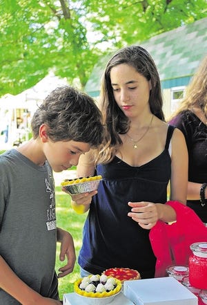 Kelsey Feit, 14, and Connor Feit, 11, of Long Island enjoyed looking through the soy candles made by Country Candles.