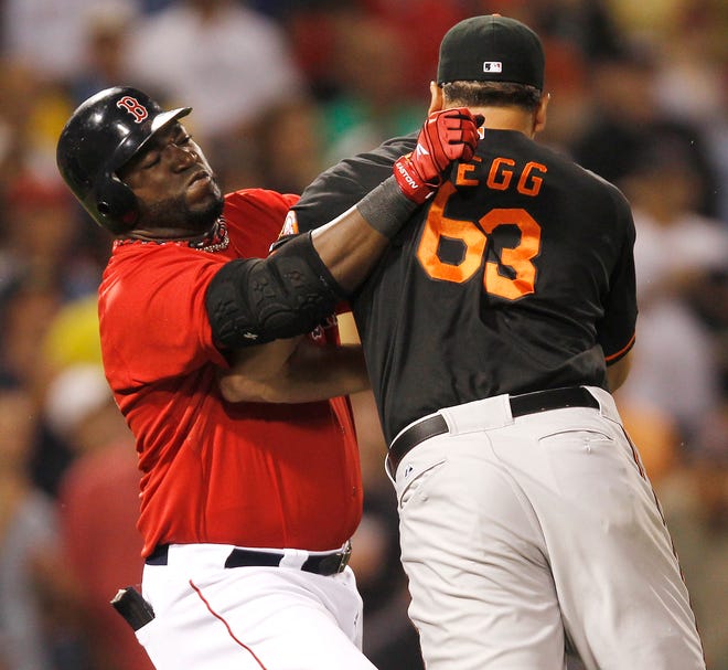 Baltimore Orioles relief pitcher Kevin Gregg (63) fights with Boston Red Sox designated hitter David Ortiz after they exchanged words after Ortiz flied out during the eighth inning of a baseball game at Fenway Park in Boston on Friday, July 8, 2011. (AP Photo/Winslow Townson)