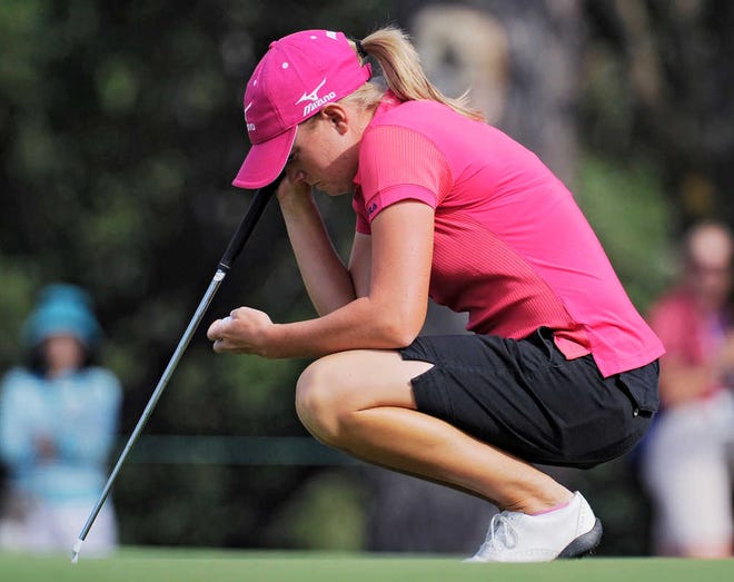 Stacy Lewis looks at her golf ball as she lines up a putt on the 10th hole as she finishes the weather delayed first round of the Women's U.S. Open golf tournament at the Broadmoor Golf Club on Friday, July 8, 2011, in Colorado Springs, Colo. (AP Photo/Chris Carlson)