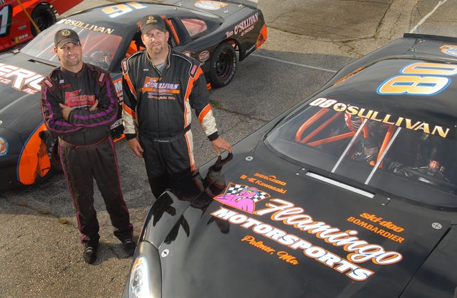 Brothers Mike O'Sullivan, left, and Tom O'Sullivan, right, both of Springfield, Mass. pose with their Late Model (Tom's car at left) and Super Late Model (Mike's car at right) before competing in feature races at the Thompson Speedway Thursday, July 7, 2011.