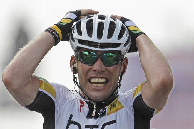 Mark Cavendish celebrates as he crosses the finish line to win theseventh stage of the Tour de France yesterday.