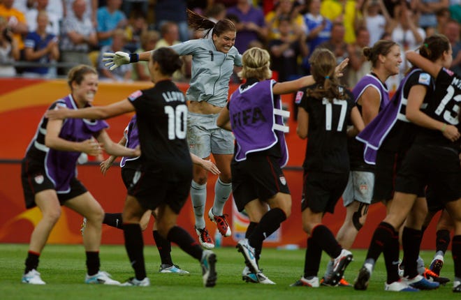 United States goalkeeper Hope Solo jumps in celebration with teammates after the U.S. won in a penalty shootout the quarterfinal match between Brazil and the United States at the Women's Soccer World Cup in Dresden, Germany, on Sunday