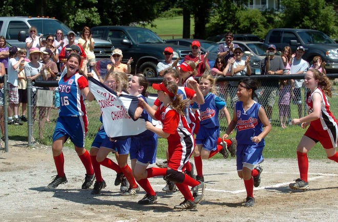 The SCF softball team does avictory lap after beating Jewett City in the District 11, 9-10 year old softball championship game in Franklin.