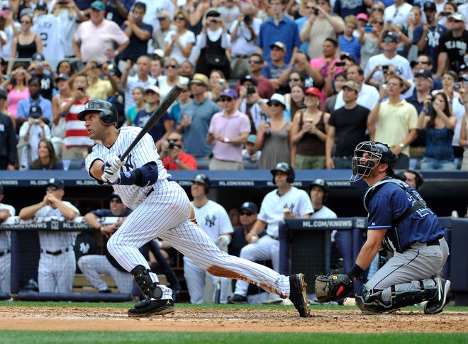The Yankees' Derek Jeter hits a solo home run for his 3,000th career hit off of Rays starting pitcher David Price in the third inning of Saturday's game at Yankee Stadium in New York. Jeter became the 28th major leaguer to hit the milestone and also the first Yankees player.