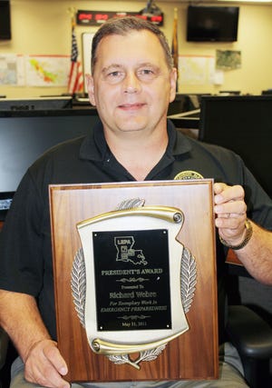 Ascension Parish Office of Homeland Security and Emergency Preparedness Director Rick Webre is shown holding the Louisiana Emergency Preparedness Association’s “President’s Award 2011.” Webre received LEPA’s highest award during the recent Louisiana Emergency Preparedness Association Conference held in New Orleans. The Association presented the award to Webre for writing the curriculum and certifying examination for a new Statewide Emergency Manager Training Program.