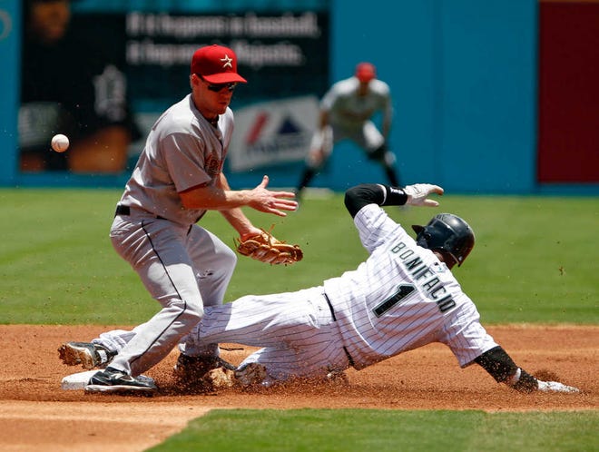 Florida's Emilio Bonifacio (1) steals second base as Houston second baseman Matt Downs is unable to catch the throw from catcher Carlos Corporan during the Marlins' 5-4 win Sunday in Miami.