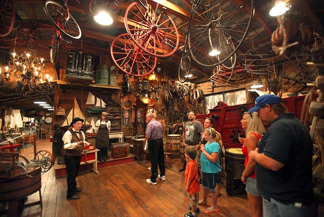 Visitors to Old Town Trolley Tours' Oldest Store Museum are led through the warehouse by tour guides, Amy Mackay, left, and Jordan Dennis, second from left, on Thursday. By DARON DEAN, daron.dean@staugustine.com