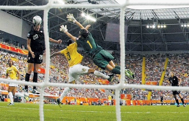 Abby Wambach (left) of the United States heads in a goal against
Brazil on Sunday in the World Cup semifinals in Dresden, Germany.
The Americans beat the Brazilians 5-3 in penalty kicks after a 2-2
tie.