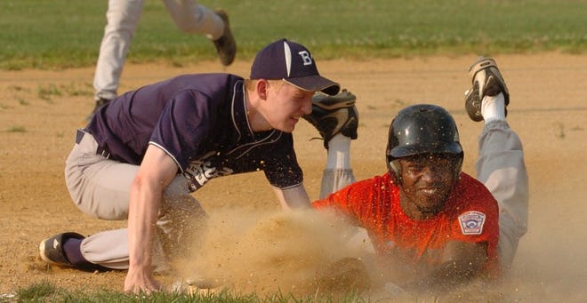 Kyle Batie of Willingboro steals third base while Brian Eifert
of Burlington Township attempts the tag during a senior Babe Ruth
game on Tuesday.