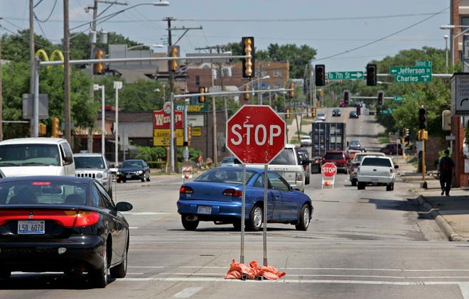 Traffic moves along East State Street between Sixth and Ninth streets as stoplights are without power Tuesday, July 12, 2011, after recent storms in Rockford.