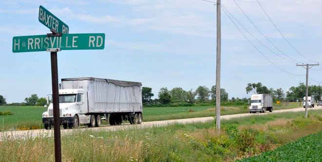 Trucks drive down Baxter Road on Monday, July 11, 2011, in southern Winnebago County. Winnebago County may partner with Cherry Valley and New Milford to offer development incentives in the area.