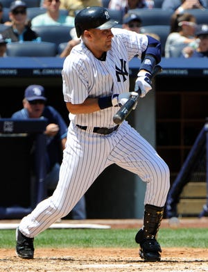 New York Yankees shortstop Derek Jeter lays down a bunt for a single against the Tampa Bay Rays. The Associated Press