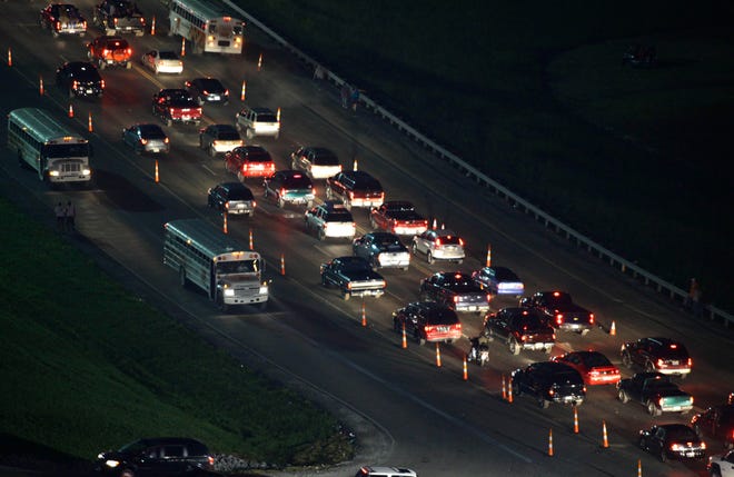 Traffic waits to get out after the inaugural NASCAR Sprint Cup Series race at the Kentucky Speedway in Sparta, Ky., early Sunday morning. The Associated Press