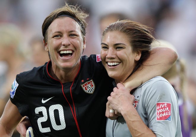 United States forward Abby Wambach, left, and goalkeeper Hope Solo celebrate Sunday after beating Brazil. The Associated Press