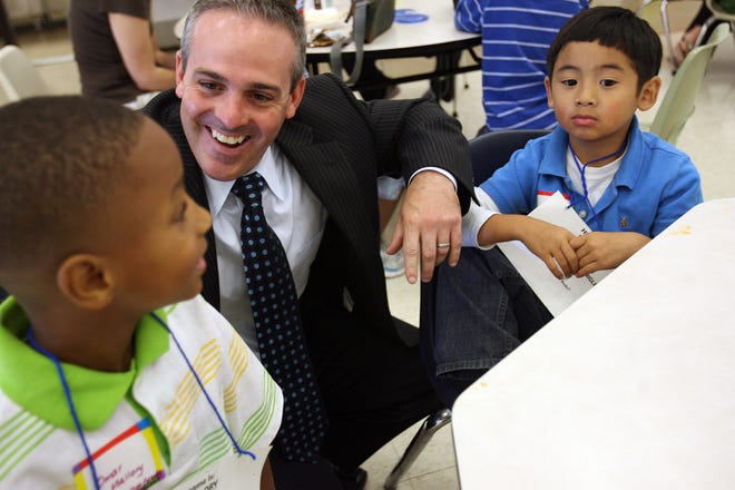 New Brockton School Superintendent Matthew Malone meets first-graders Omar Mallory, left, and Nathan Vo on Wednesday during the first day of school at the  Downey School.