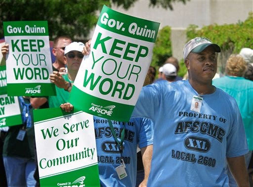 American Federation of State, County and Municipal Employees, AFSCME, walk an informational picket line Tuesday July 12, 2011, in Springfield, Ill. Illinois state employees are protesting about Quinn's decision not to pay their contractual raises. Liken it to attacks on collective bargaining in Wisconsin, Ohio and elsewhere. (AP Photo/Seth Perlman)