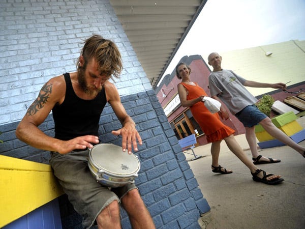 Street musician Tyler Guvetis plays his bongos Sunday morning in Carolina Beach.