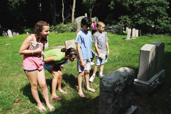 HISTORY: The Swansea summer writing camp members, visited the cemetery behind Town Hall. Shown here from left are Julia Ouellette, Gabrielle Hunt, William Lopes and Matt Beaupre.