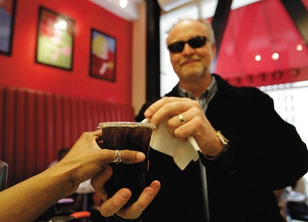 Eric Risberg/The Associated Press
Customer Brad Shaffer reaches for an iced coffee at Cafe Madeleine in San Francsico. Iced coffee drinks today rely on premium beans, just as with hot coffee, and there are special processes used to bring out the best in the flavor.
