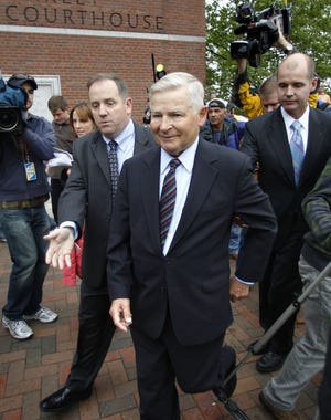 Former Mass. Senate President William Bulger is escorted from the federal courthouse after the first appearance for his brother James "Whitey" Bulger and his girlfriend Catherine Greig, in Boston Friday, June 24, 2011. Bulger and Greig were apprehended Thursday, June 23, 2001, in Santa Monica, Calif., after 16 years on the run.
