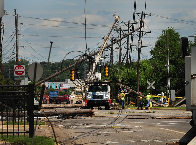Crews continue to fix the down lines and clean up the mess after Monday's storm Tuesday afternoon. Dennis R.J. Geppert/Sentinel Staff