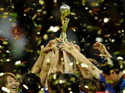 Japan players celebrate with the trophy following the final match between Japan and the United States at the Women’s Soccer World Cup in Frankfurt, Germany, Sunday, July 17, 2011.
